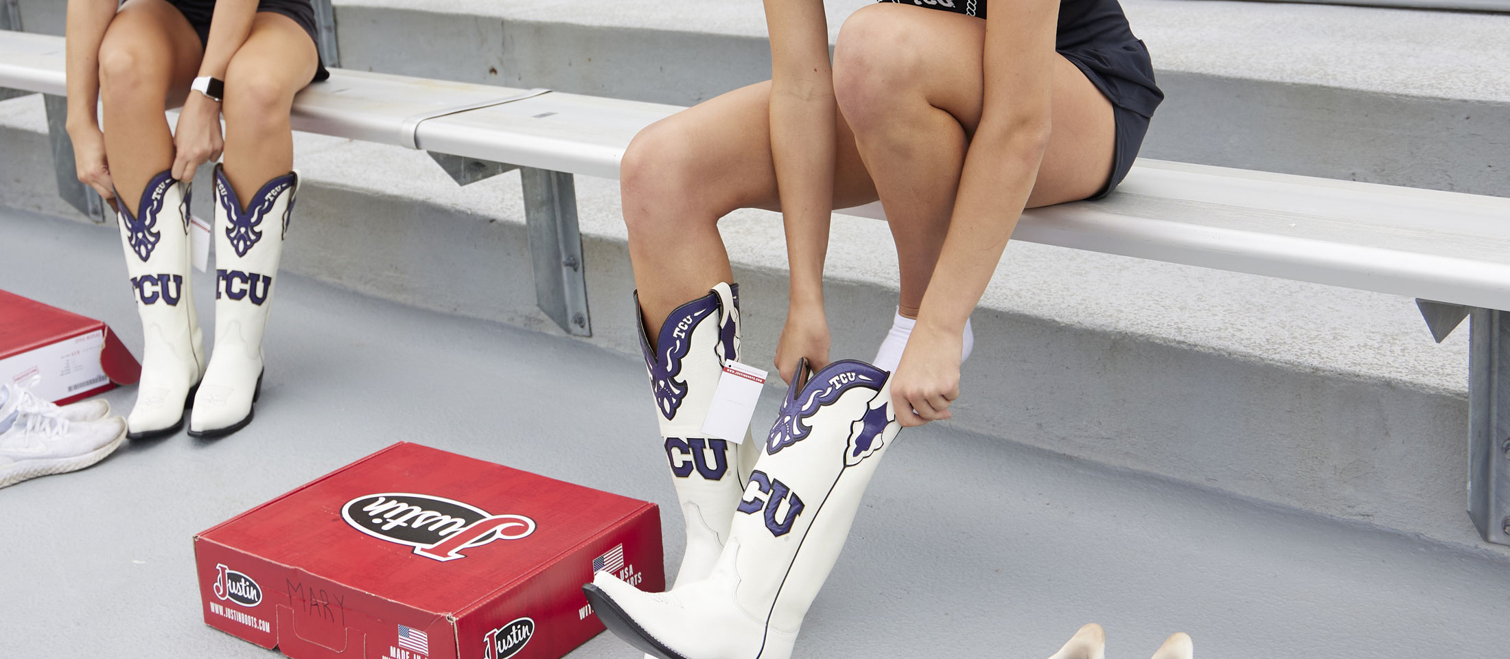 Two TCU showgirls try on their custom Justin Boots for the first time.